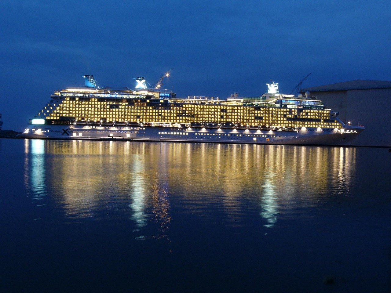Luxury cruise ship sailing at sunset with ocean view